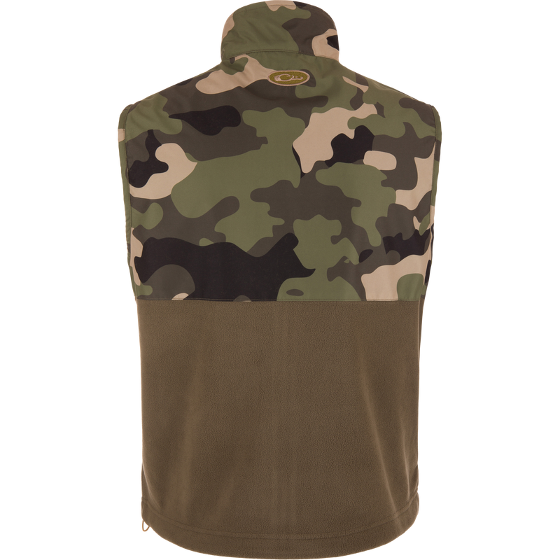 MST Eqwader Vest featuring a camouflage design, showcasing chest pockets and fleece lower body for insulation and breathability, ideal for hunting and outdoor activities.
