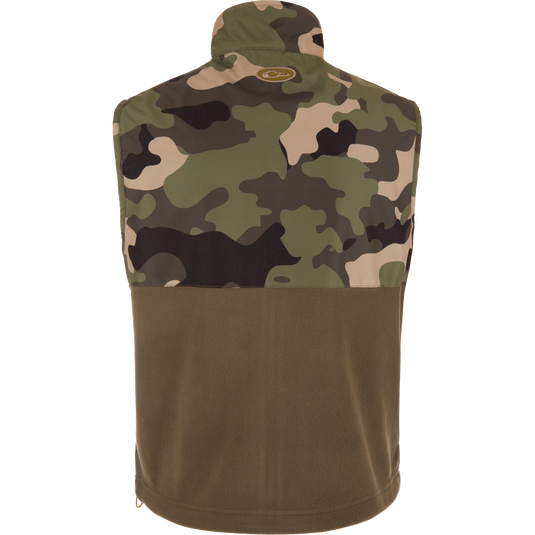 MST Eqwader Vest featuring a camouflage design, showcasing chest pockets and fleece lower body for insulation and breathability, ideal for hunting and outdoor activities.