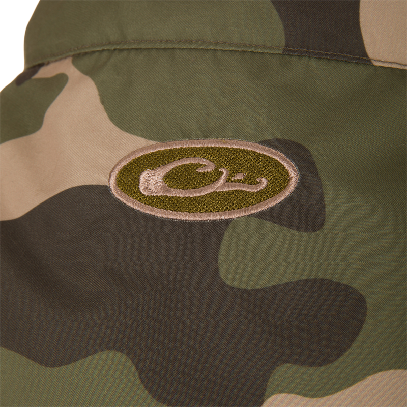 MST Eqwader Vest featuring a close-up of its waterproof shoulder fabric, logo, and functional pockets, ideal for hunting with breathable fleece lower torso.