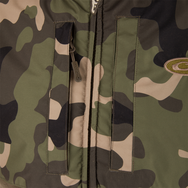 MST Eqwader Vest close-up showcasing military camouflage pattern, waterproof shoulders, breathable fleece lower torso, and zippered chest pockets for secure storage.
