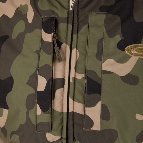 MST Eqwader Vest close-up showcasing military camouflage pattern, waterproof shoulders, breathable fleece lower torso, and zippered chest pockets for secure storage.