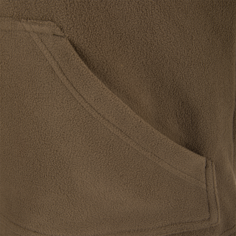 Close-up of MST Eqwader Vest, showcasing its fleece texture, Magnattach™ chest pocket, and zippered pocket for secure storage in hunting conditions.
