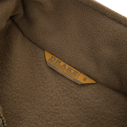 MST Eqwader Vest close-up showing detailed labels and fabric texture, highlighting waterproof upper materials and breathable fleece lower body for hunting versatility.