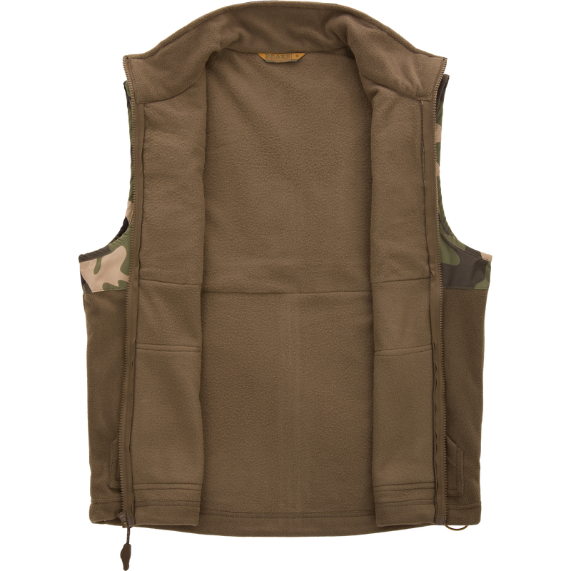 MST Eqwader Vest, featuring camouflage pattern, showcases waterproof, breathable upper with fleece lower, and chest pockets for secure storage, ideal for hunting.