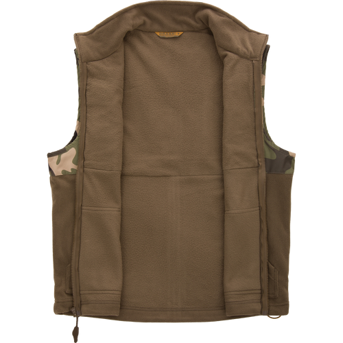 MST Eqwader Vest, featuring camouflage pattern, showcases waterproof, breathable upper with fleece lower, and chest pockets for secure storage, ideal for hunting.