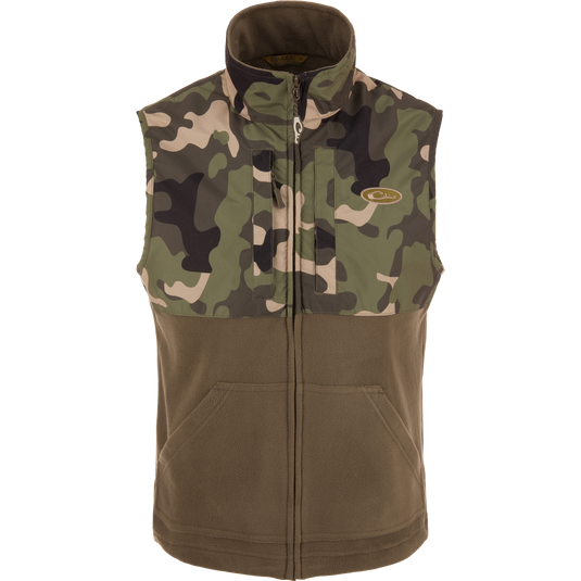 MST Eqwader Vest featuring camouflage design, mid-layer insulation, waterproof shoulders, and breathable fleece lower body, with secure chest pockets for hunting essentials.