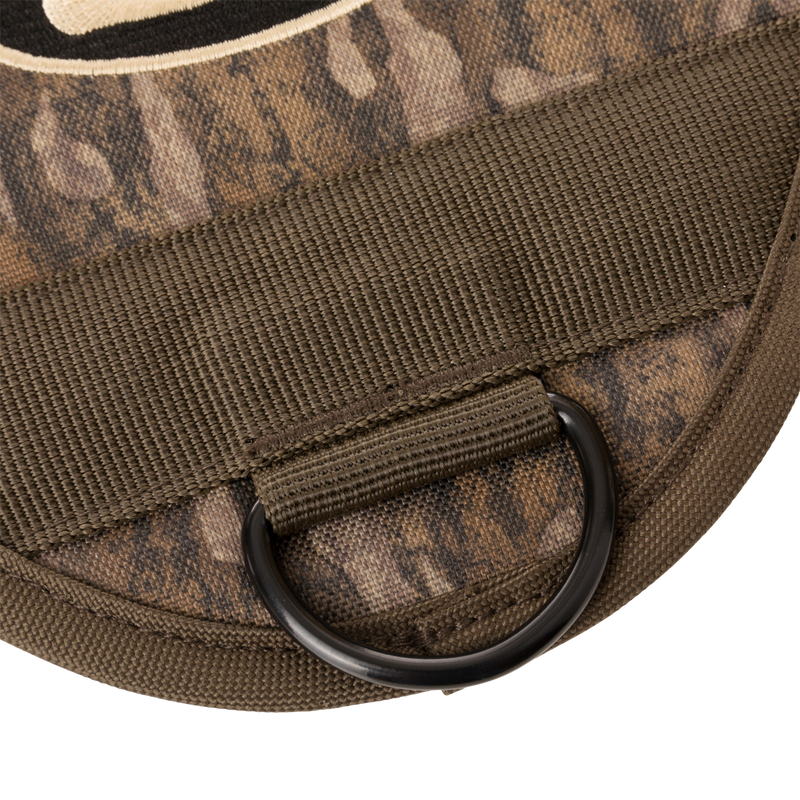 3-Way Duck Tote's olive-drab nylon strap with black metal D-ring attached to camouflage fabric, highlighting its durable design for hunting versatility.