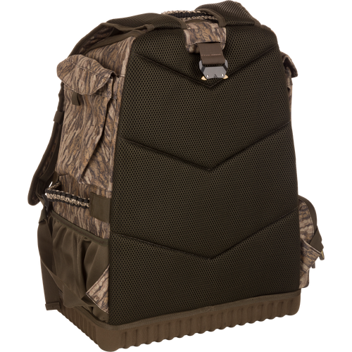 Tree Hugger Timber Pack: rugged camo-patterned backpack with padded mesh back, molded hard bottom, adjustable straps, and camouflage side pouches for hunting gear storage.