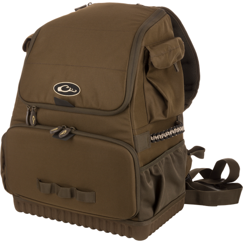 Tree Hugger Timber Pack, a rugged olive-green daypack with a flap top, front zippered pocket, side mesh pouch, padded straps, and paracord detailing.