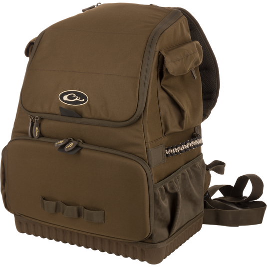 Tree Hugger Timber Pack, a rugged olive-green daypack with a flap top, front zippered pocket, side mesh pouch, padded straps, and paracord detailing.