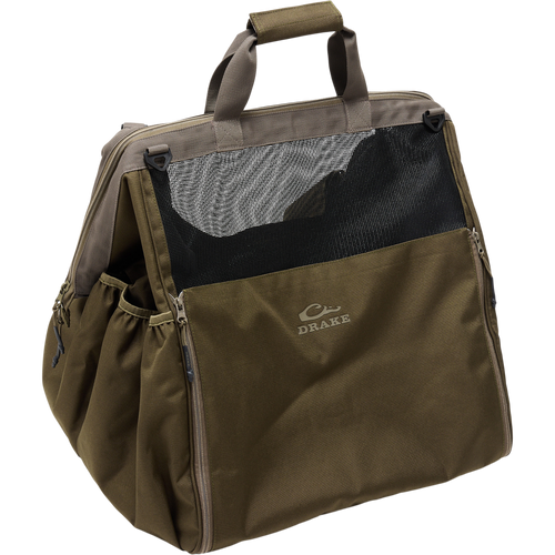 Guardian Elite Wader Bag with Drake logo, featuring a trapezoidal, ventilated design, hand and backpack straps, zippered floor mat, and side boot pockets for waterfowl gear.