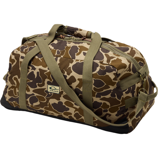 Throwback 80 Duffle Bag, a durable camouflage bag with sturdy cotton straps, suede bottom, and antique bronze buckles, ideal for outdoor adventures.