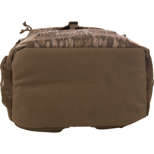 Underside of the Drake Day Pack, showcasing heavy-duty fabric with mesh side pockets, designed for rugged adventures with comfort shoulder straps and versatile storage options.