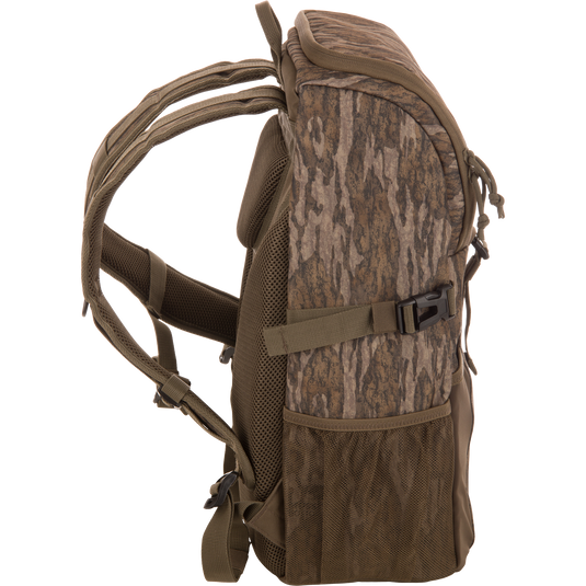 Drake Day Pack in camouflage, featuring padded shoulder straps, mesh side pockets, and compression straps, ideal for outdoor adventures with rugged, water-resistant construction.