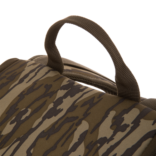 Camouflage-patterned Tree Hugger Timber Day Pack showcasing its woven carry handle on rugged HD2™ material, designed for outdoor excursions with water-resistant features.