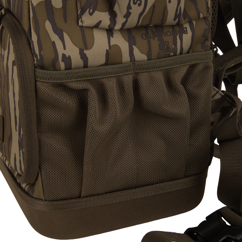 Tree Hugger Timber Day Pack with camouflage pattern, mesh side pockets, adjustable strap, and plastic buckle, designed for rugged outdoor use with waterproof and floatable features.