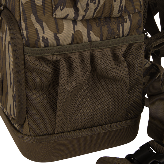 Tree Hugger Timber Day Pack with camouflage pattern, mesh side pockets, adjustable strap, and plastic buckle, designed for rugged outdoor use with waterproof and floatable features.