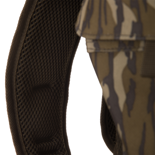 Close-up of Tree Hugger Timber Day Pack's padded, mesh-covered shoulder strap, showcasing its camouflage fabric, designed for durability and easy gear access during outdoor adventures.