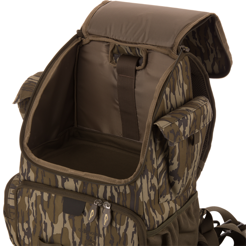 Tree Hugger Timber Day Pack with open main compartment, side pouches, front zip pocket, adjustable straps, showcasing its rugged, water-resistant design for outdoor adventures.