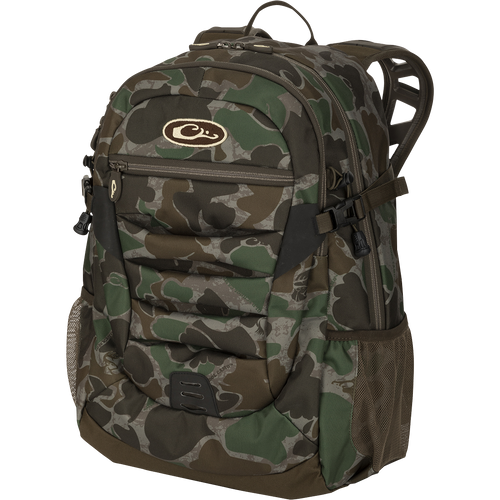 Youth Camo Daypack featuring camouflage pattern, large zippered storage, hydration pockets, padded straps, ideal for hunting and casual use. Compact design for essential items.