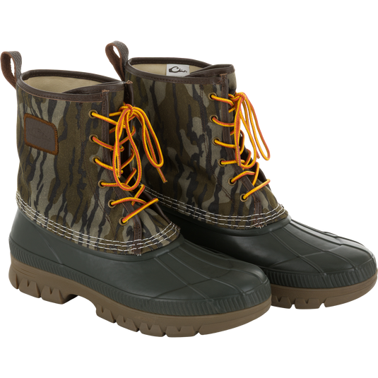 Throwback 80 Waxed Canvas Lace Up Duck Boot with waterproof rubber bottom, camo-print canvas upper, yellow-and-orange laces, ideal for wet and rugged outdoor conditions.