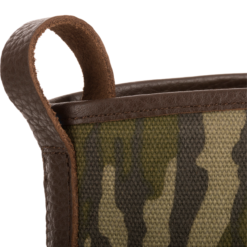 Close-up of Throwback 80 Waxed Canvas Slip On Duck Boot's camo-patterned canvas with brown leather trim and pull-loop, showcasing its rugged, durable design.