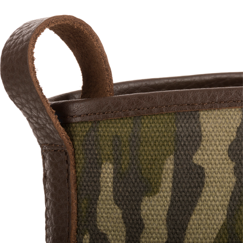 Close-up of Throwback 80 Waxed Canvas Slip On Duck Boot's camo-patterned canvas with brown leather trim and pull-loop, showcasing its rugged, durable design.