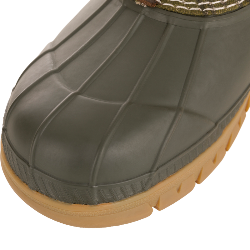 Close-up of Throwback 80 Waxed Canvas Slip On Duck Boot's rubber toe and midsole, highlighting its durable, waterproof design ideal for demanding outdoor conditions.