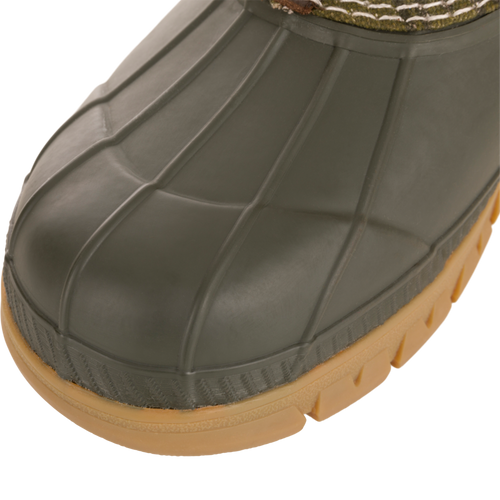 Close-up of Throwback 80 Waxed Canvas Slip On Duck Boot's rubber toe and midsole, highlighting its durable, waterproof design ideal for demanding outdoor conditions.