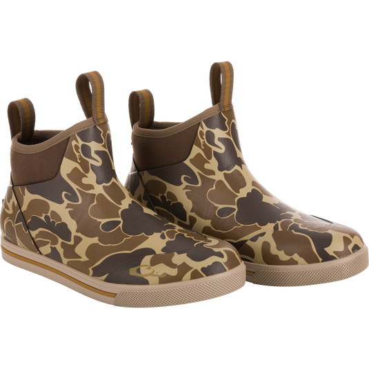 Camp Deck Boot in camouflage print; ankle-height, slip-on style with waterproof neoprene, rubber sole for traction, and pull-tabs for easy wear.