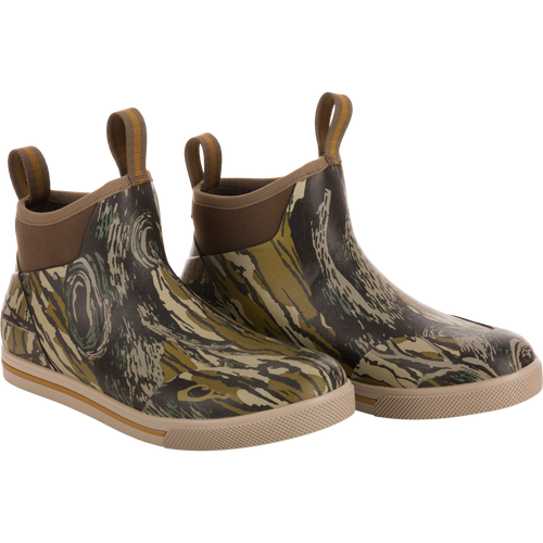 A pair of camouflage patterned waterproof boots designed for outdoor use, featuring a non-marking rubber outsole.
