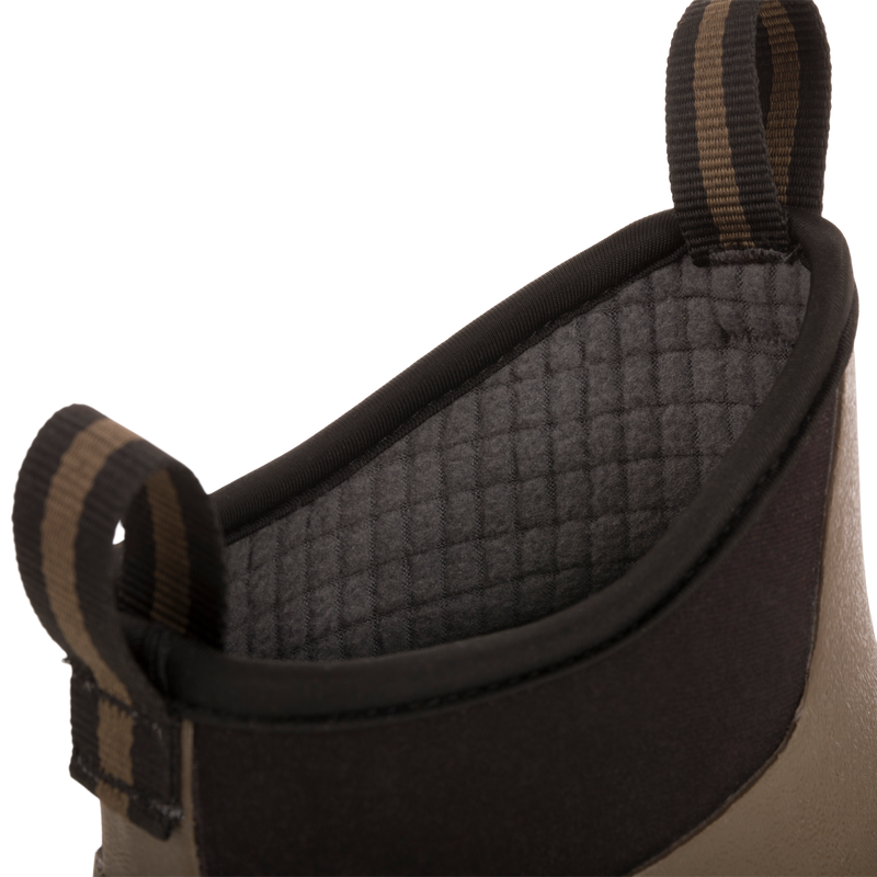 Camp Deck Boot close-up: neoprene cuff with quilted grey lining, striped pull-loops, and tan/olive shell, showcasing waterproof design for outdoor adventures.