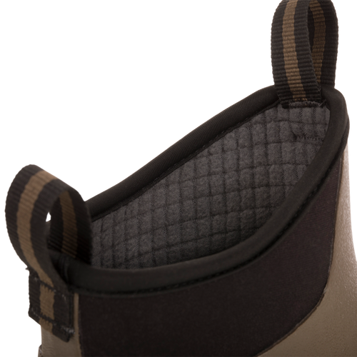 Camp Deck Boot close-up: neoprene cuff with quilted grey lining, striped pull-loops, and tan/olive shell, showcasing waterproof design for outdoor adventures.