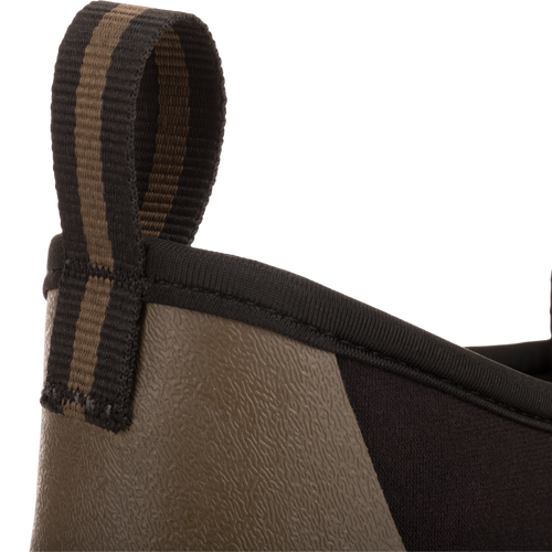 Camp Deck Boot close-up showing textured rubber lower and neoprene upper with striped pull-tab, highlighting its waterproof design and superior traction for outdoor adventures.