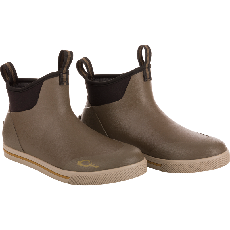 Camp Deck Boot featuring ankle-height design, olive rubber upper with black neoprene collar, and non-marking siped outsole for excellent traction on wet surfaces.