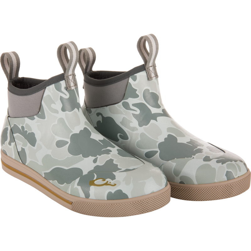 Camp Deck Boot with camouflage print, neoprene collar, pull-tabs, and tan rubber outsoles, designed for superior outdoor functionality and waterproof comfort.
