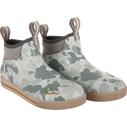 Camp Deck Boot with camouflage print, neoprene collar, pull-tabs, and tan rubber outsoles, designed for superior outdoor functionality and waterproof comfort.