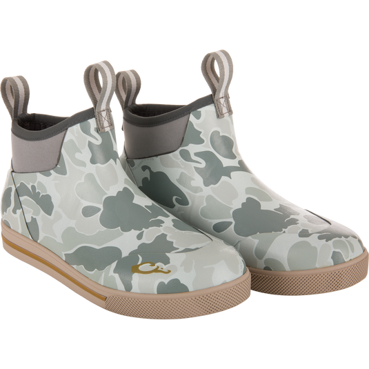 Camp Deck Boot with camouflage print, neoprene collar, pull-tabs, and tan rubber outsoles, designed for superior outdoor functionality and waterproof comfort.