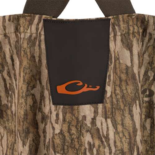 Hardline Insulated Breathable Wader featuring camo pattern, black chest panel with orange C logo, and durable shoulder straps for outdoor adventures.
