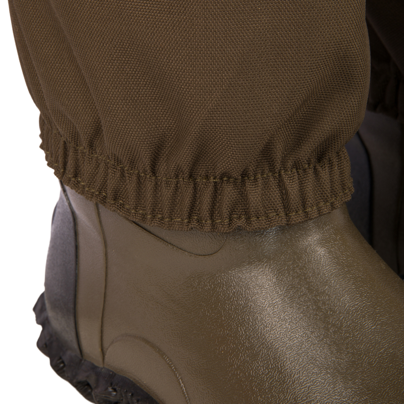 Hardline Insulated Breathable Wader close-up, showcasing the elastic-cuffed pant leg over an olive waterproof boot, designed for warmth and durability in outdoor conditions.