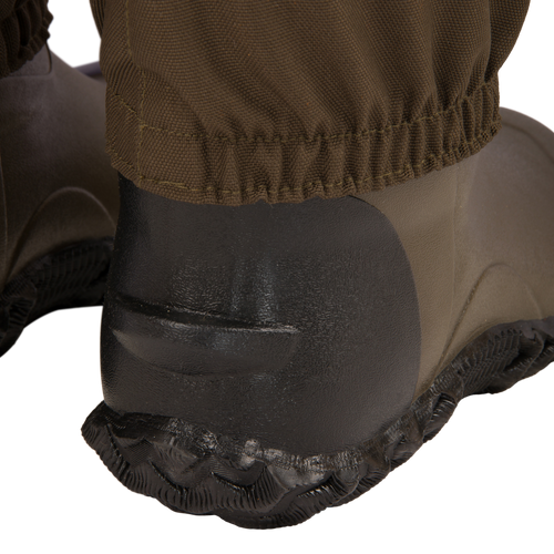 Close-up of the Hardline Insulated Breathable Wader's black molded rubber heel and sole, showcasing the durable waterproof design and cinched fabric gaiter for outdoor protection.