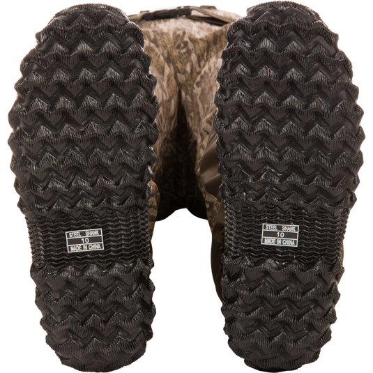 Underside view of Hardline Insulated Breathable Wader boots showing camo-pattern, zig-zag tread, and STEEL SHANK 10 MADE IN CHINA label.