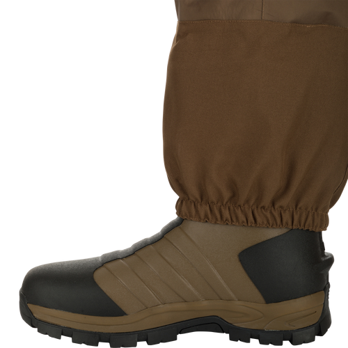 EST Waterfowler’s Hip Boot designed for marsh navigation, featuring GE3 Wader Material, athletic lug outsole, EVA midsole, and adjustable hip strap for comfort and traction.