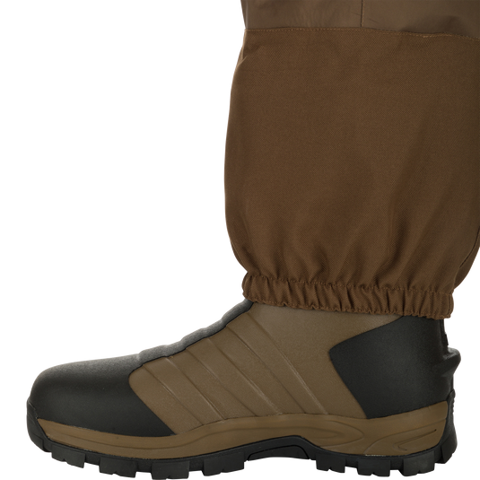 EST Waterfowler’s Hip Boot designed for marsh navigation, featuring GE3 Wader Material, athletic lug outsole, EVA midsole, and adjustable hip strap for comfort and traction.