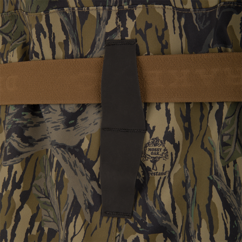 Close-up of BMF1600 Kevlar Wader with Primaloft, featuring Mossy Oak camo fabric, brown webbing strap, and black elastic tab, showcasing advanced durability and water resistance.
