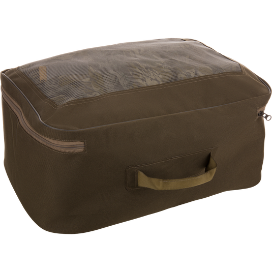 Olive-green storage cube with mesh top displaying folded garments, representing the BMF1600 Kevlar Wader's mesh carry bag inclusion for organized travel.
