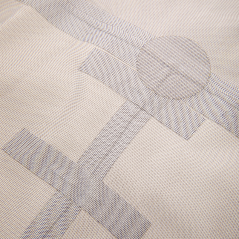 Close-up of beige fabric with pale gray woven tape strips arranged as samples, showcasing the BMF1600 Kevlar Wader with Primaloft's durable material and design innovation.