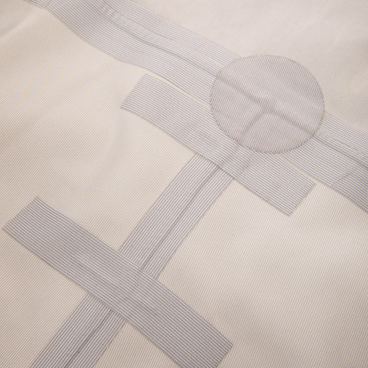 Close-up of beige fabric with pale gray woven tape strips arranged as samples, showcasing the BMF1600 Kevlar Wader with Primaloft's durable material and design innovation.