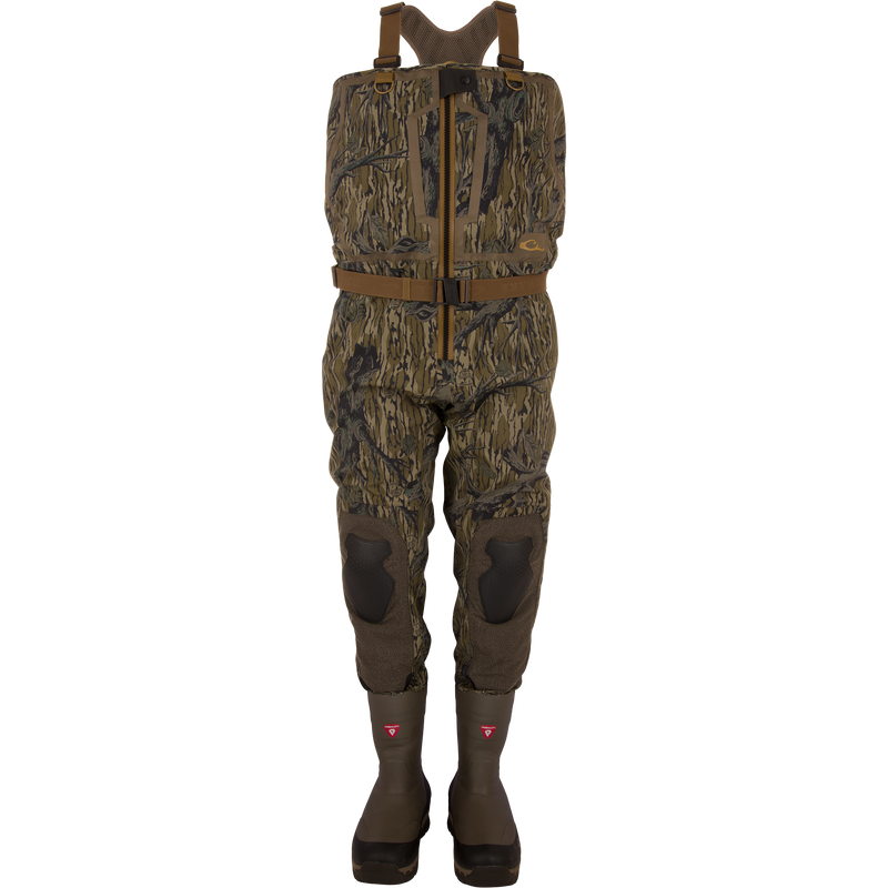 BMF1600 Kevlar Wader with Primaloft, featuring woodland camouflage, adjustable suspenders, front zipper, reinforced knees, and built-in boots for advanced waterfowl hunting protection.