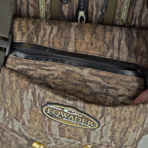 A person's hand holding a Drake Insulated Breathable Chest Wader with Sewn-in Liner, showcasing HD2 material and LokDown insulation for warmth and protection.